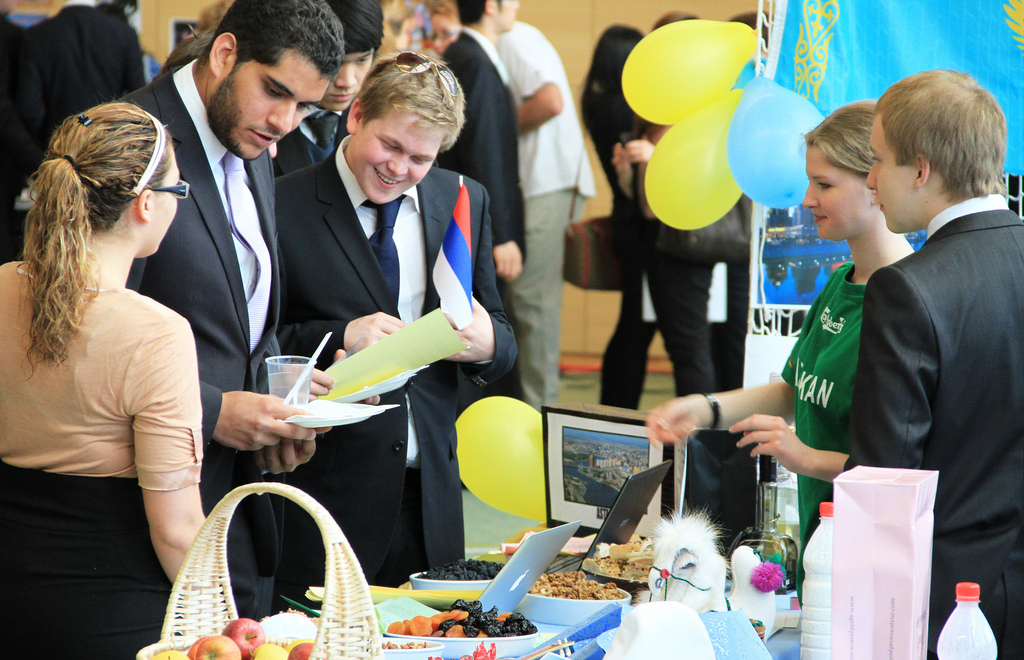 Visitors looking at merchandise at international event