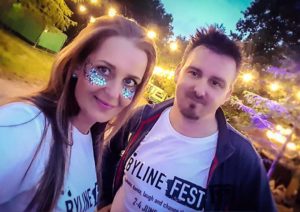 Couple wearing Byline Fest logo t shirts