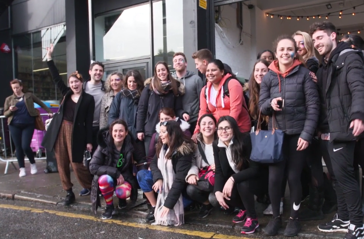 Group of students excitedly posing for photo