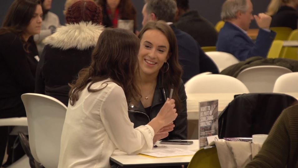 Student sitting with staff to enrol on course