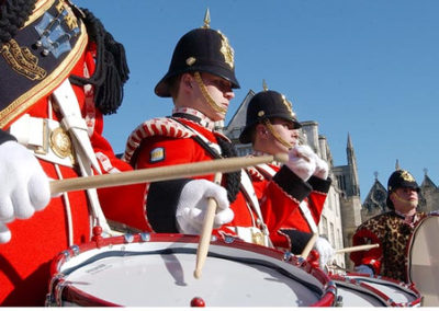 Soldiers in dress uniform marching band